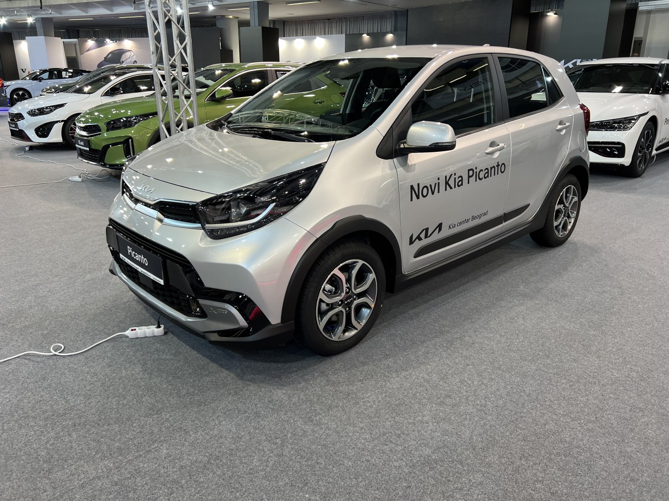 Silver compact hatchback with modern headlights and sporty alloy wheels