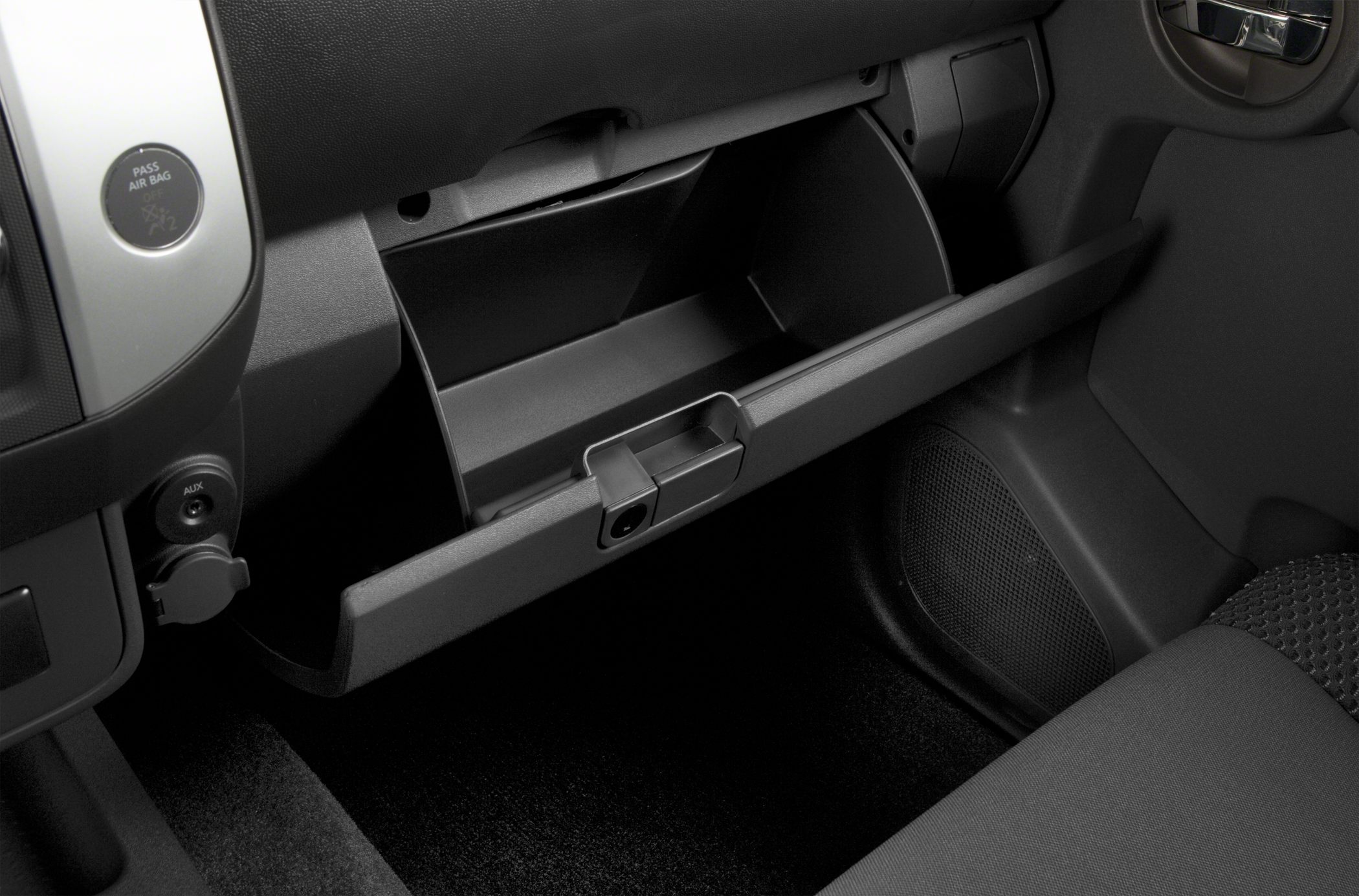 Open glovebox with dashboard interior details in SUV cabin