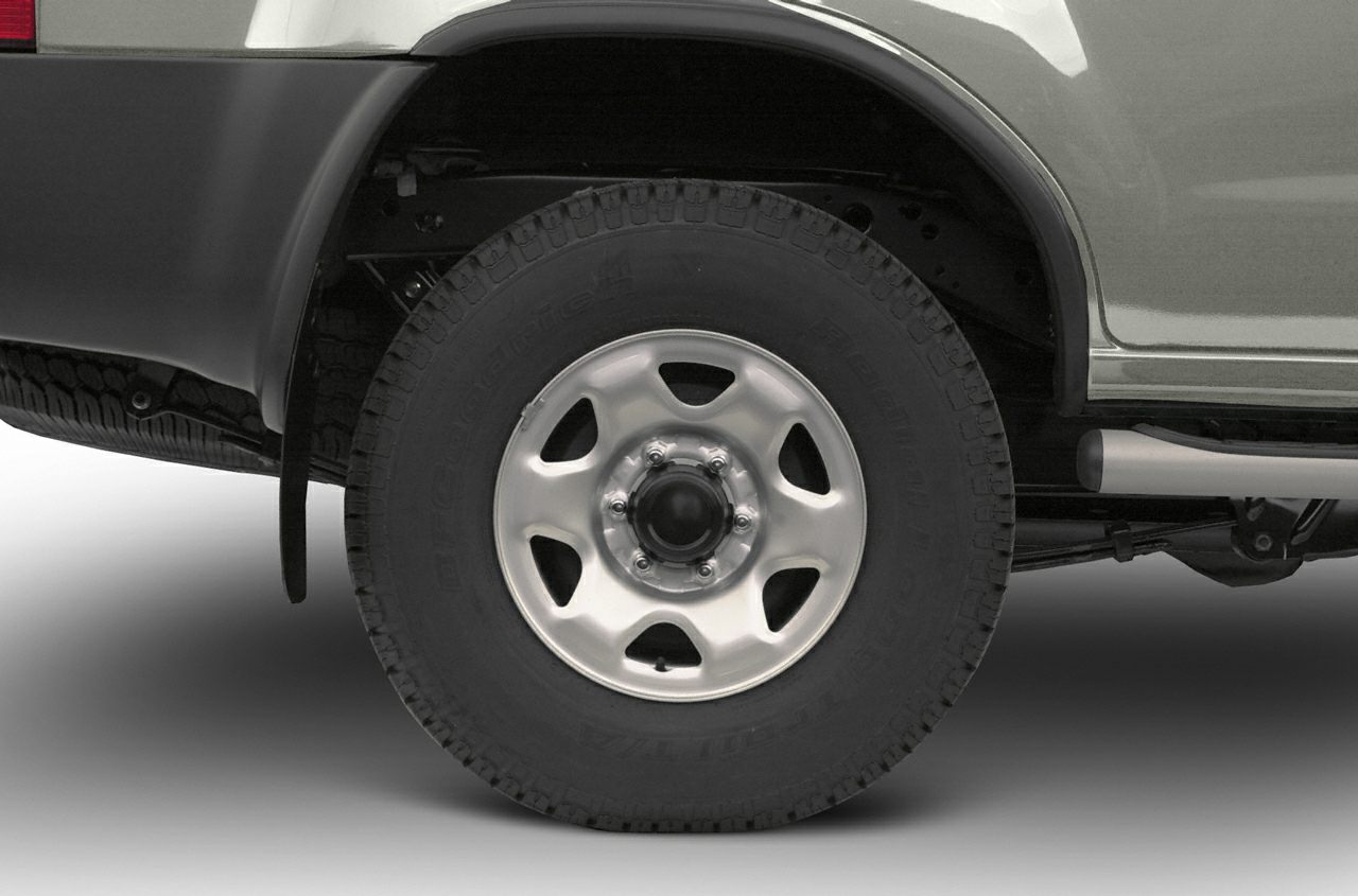 Steel wheel with off-road tire tread and visible suspension components