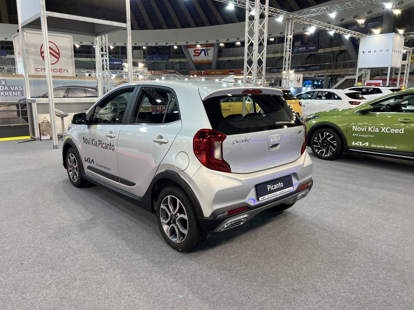 Compact hatchback with rear and side view, silver body.