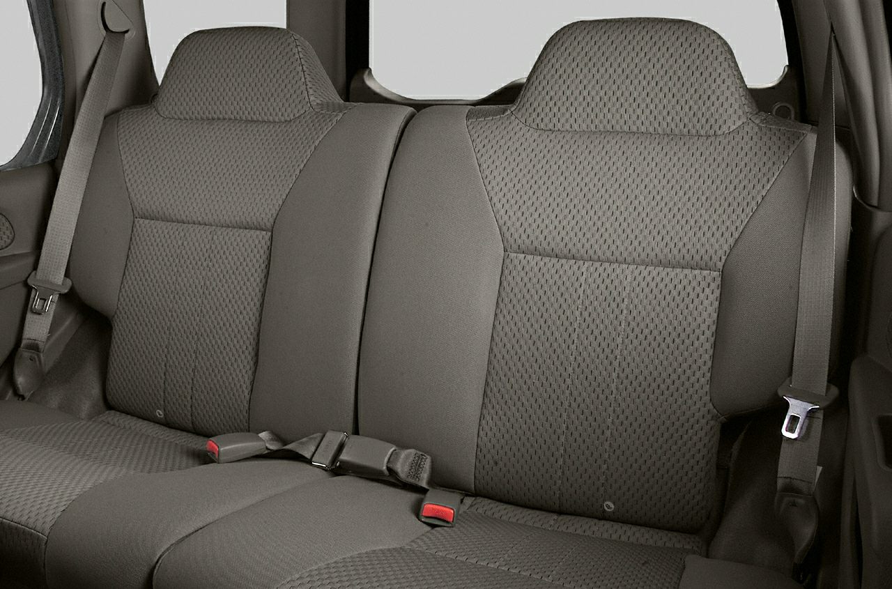 Close-up of rear car seats and seat belts with textured upholstery