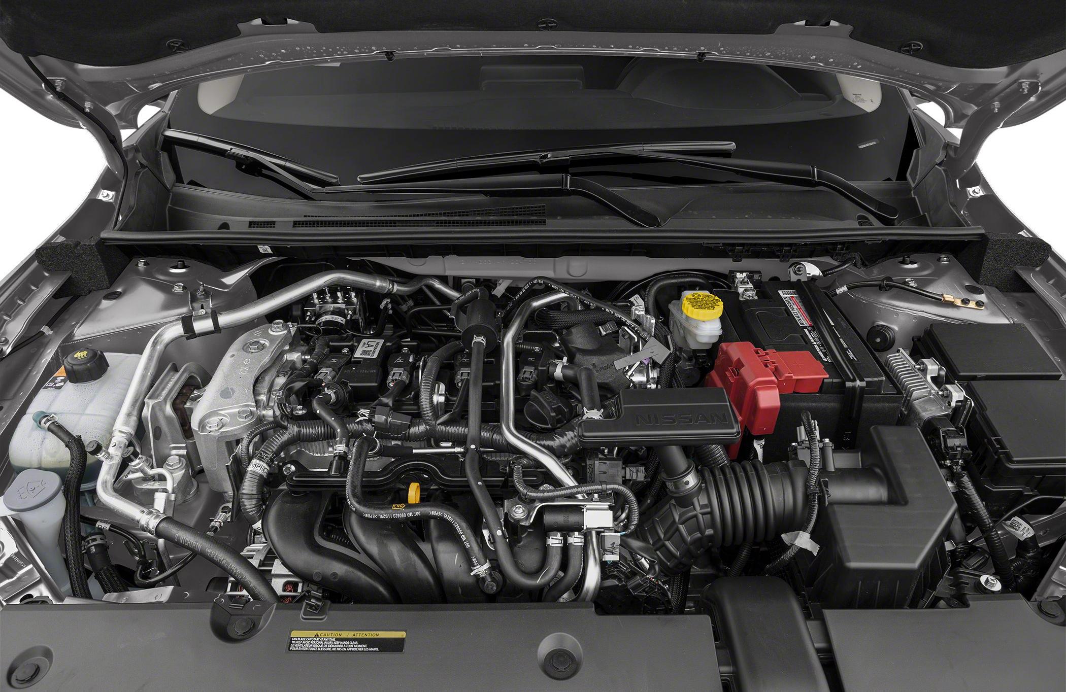 Engine compartment with hoses, battery, and fluid reservoirs under the hood