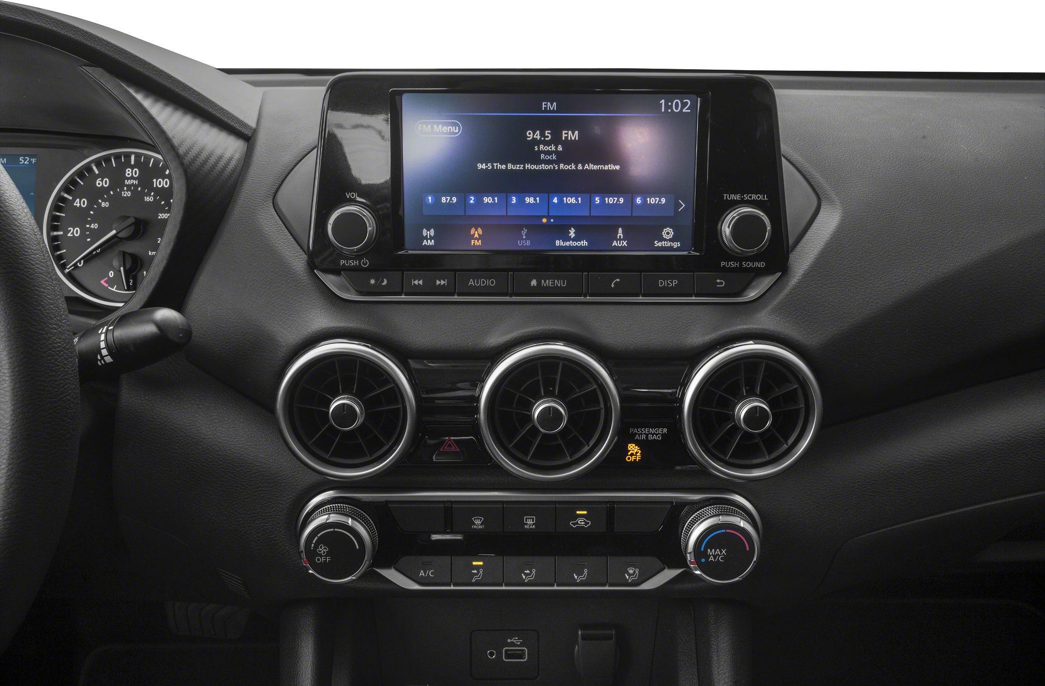 Dashboard with touchscreen infotainment and three circular air vents