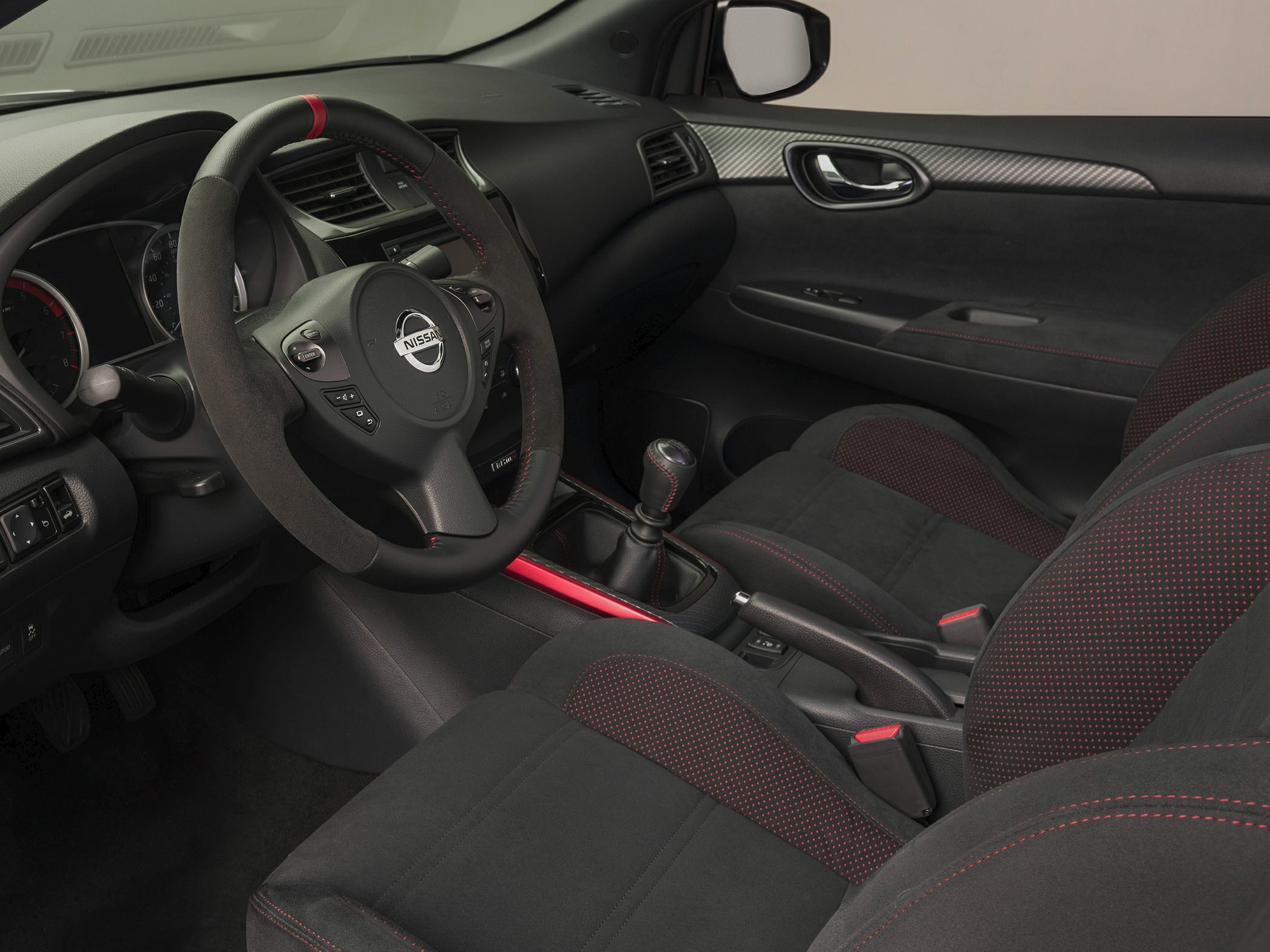 Sporty car interior with red stitching and manual gear shift