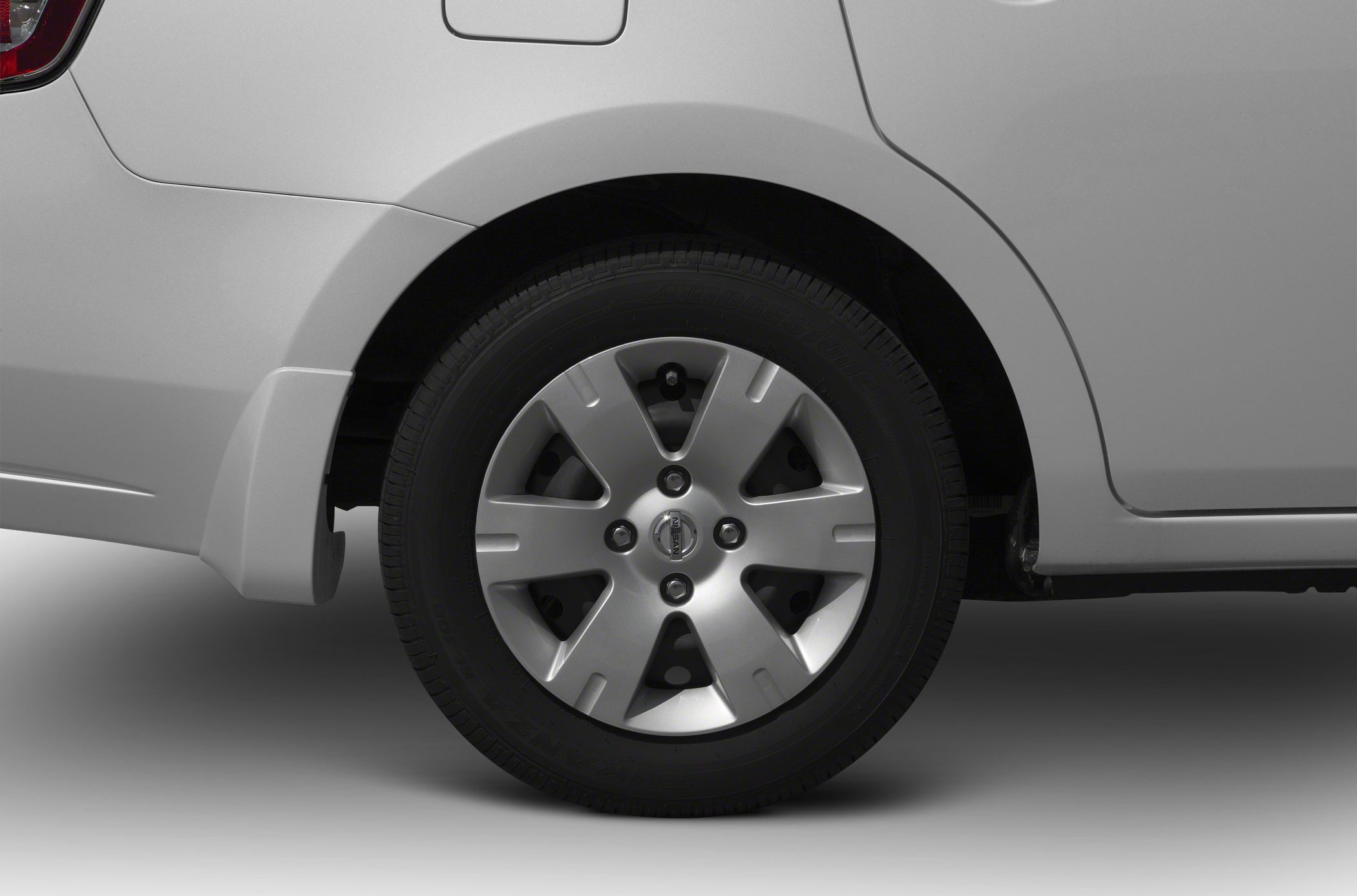 Close-up of rear wheel and silver alloy rim with tire