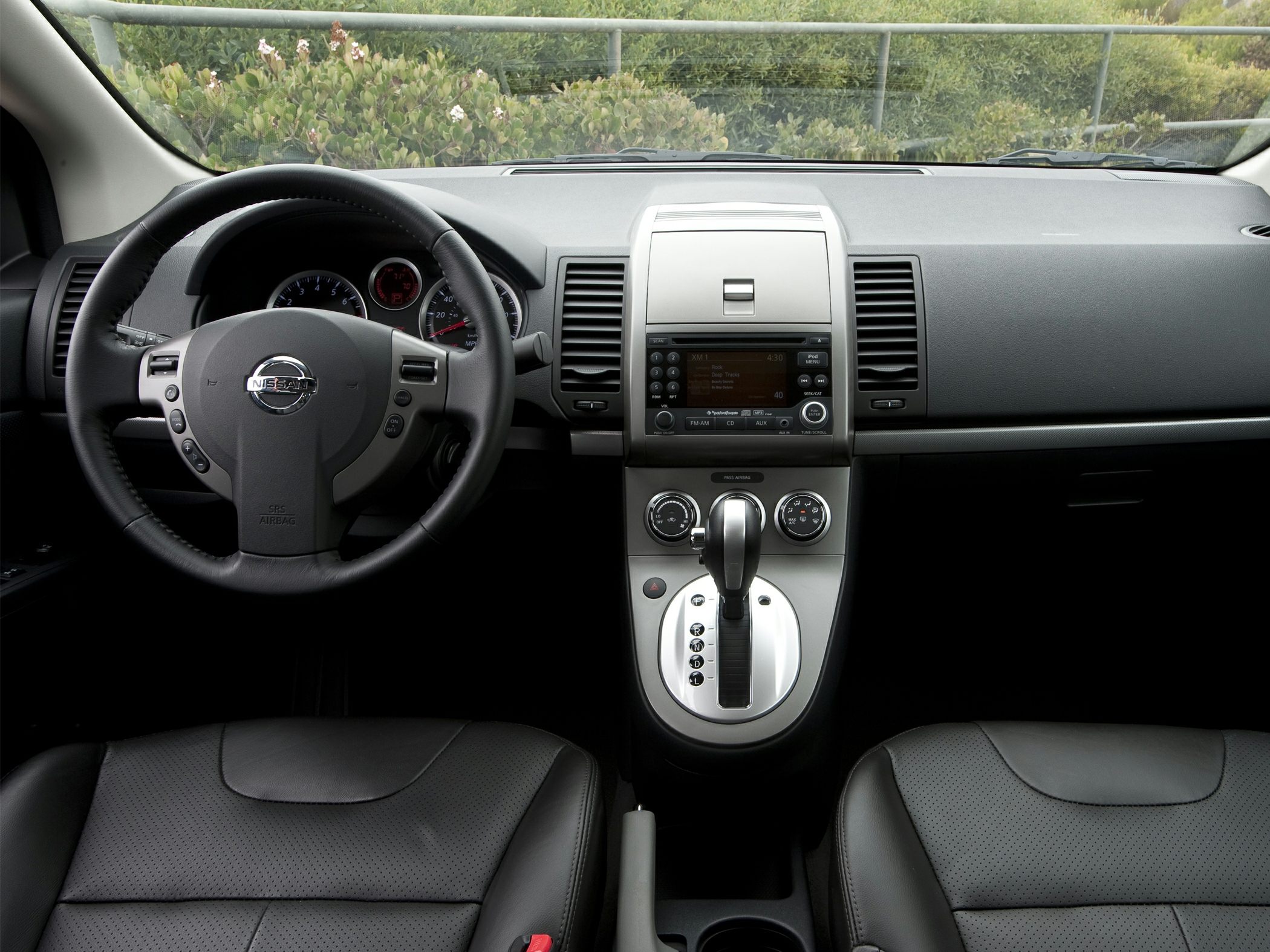 Dashboard with steering wheel, instrument cluster, and gear shift console