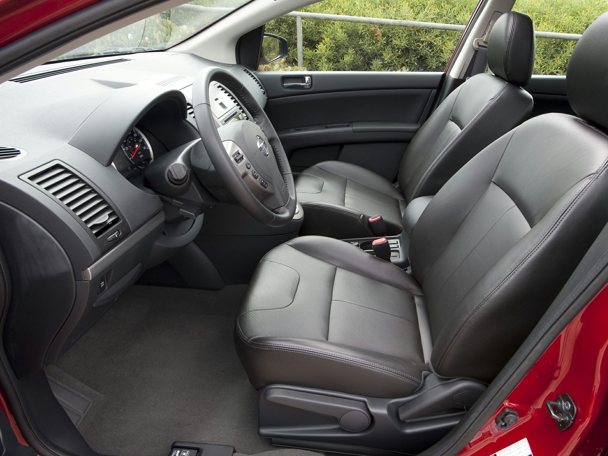 Front interior with black leather seats and dashboard view