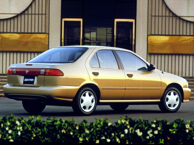Rear side view of a compact sedan with smooth lines and alloy wheels.