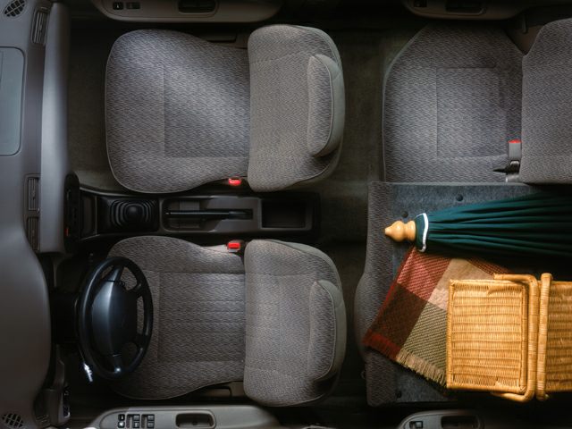Top view of car interior with front bucket seats and rear bench seating