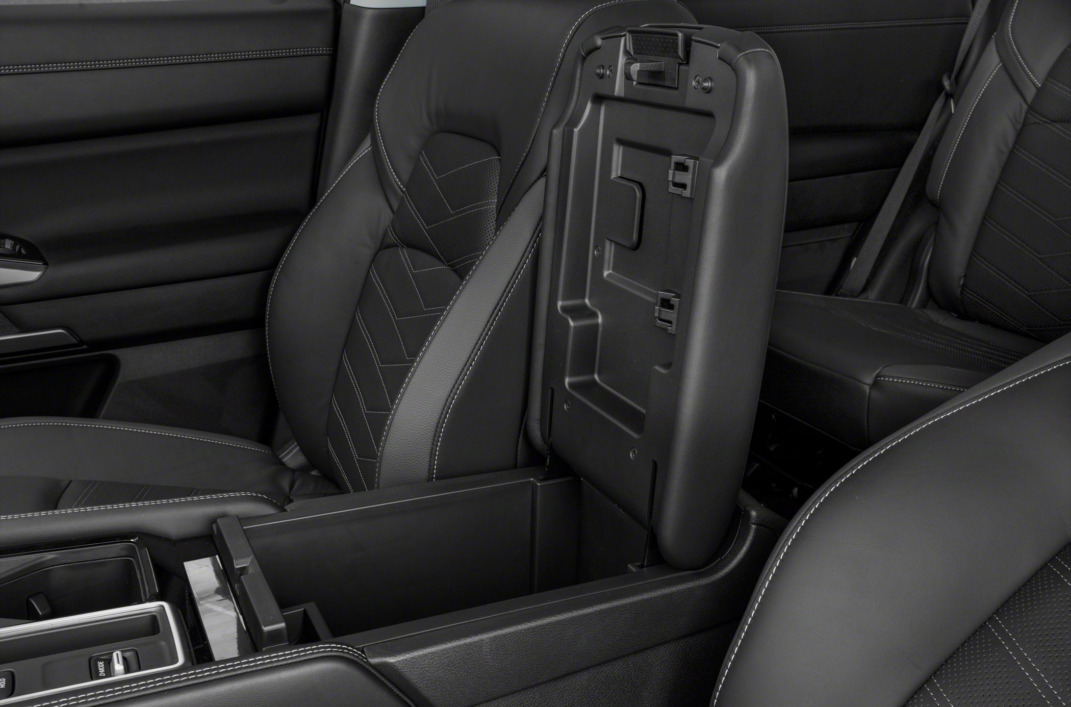 Luxury black leather seats with detailed stitching and open center console storage