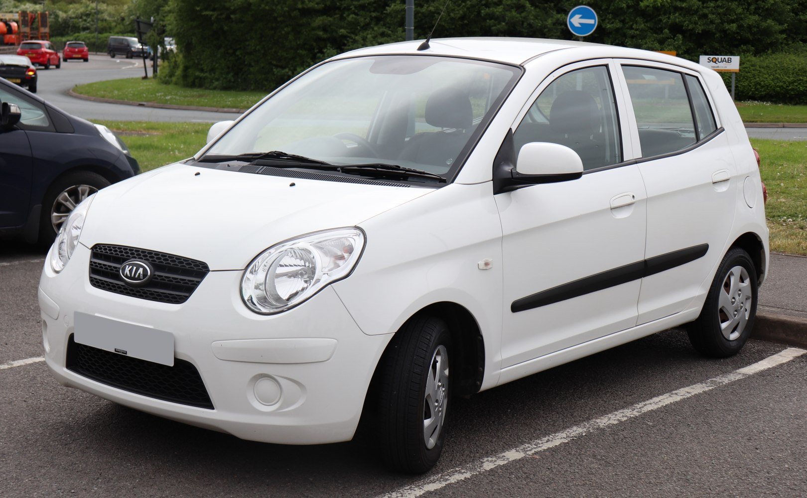Rounded headlights, black grille, compact five-door hatchback
