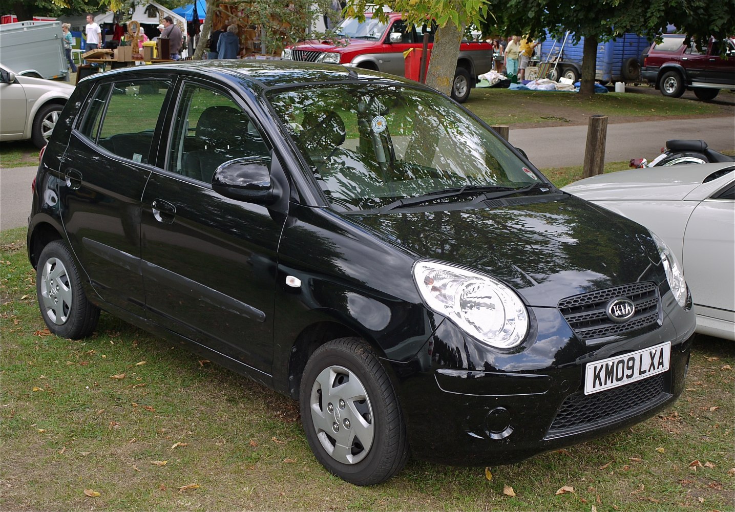 Compact hatchback with round headlights and front side view