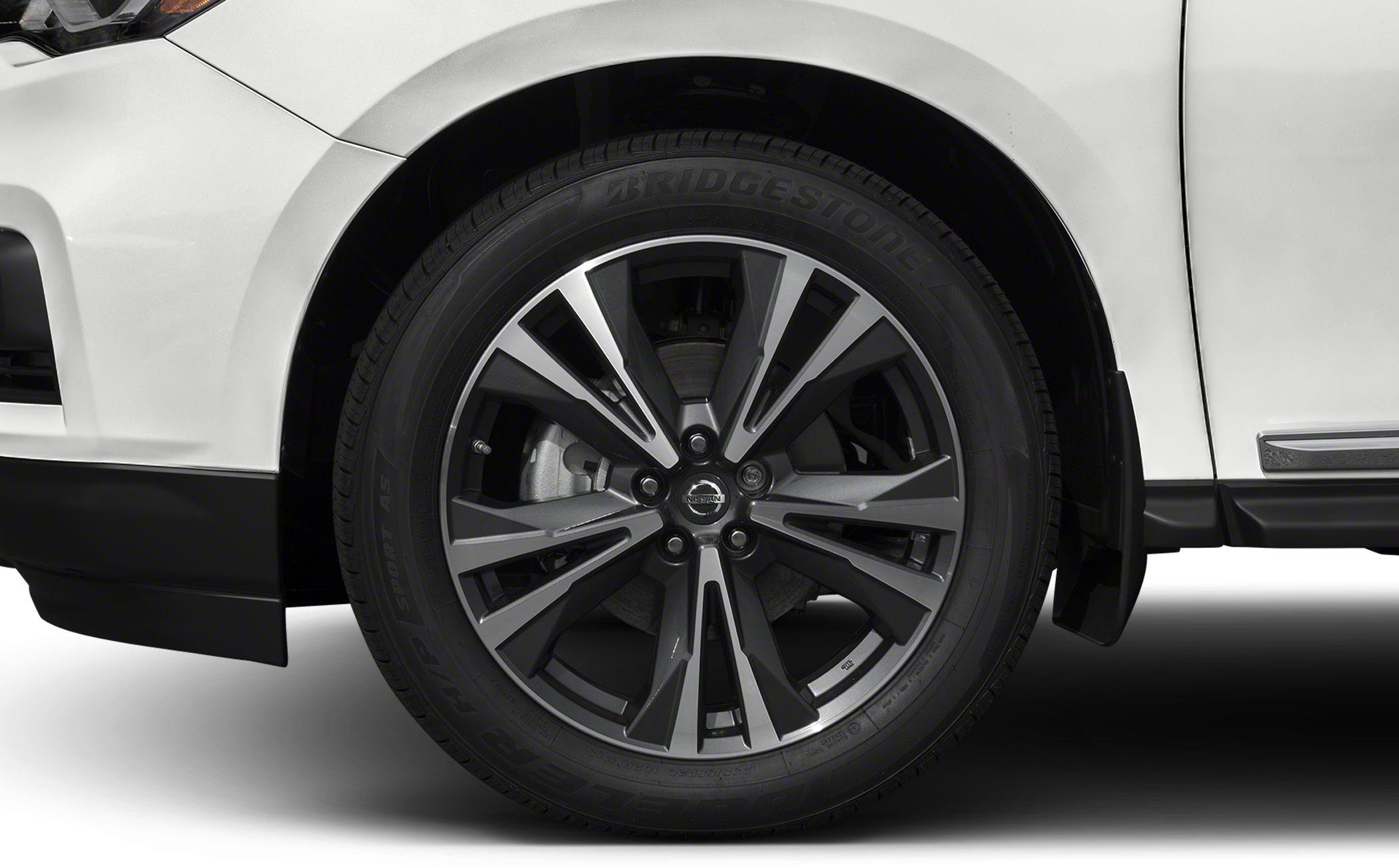 Close-up of alloy wheel with Bridgestone tire on white SUV