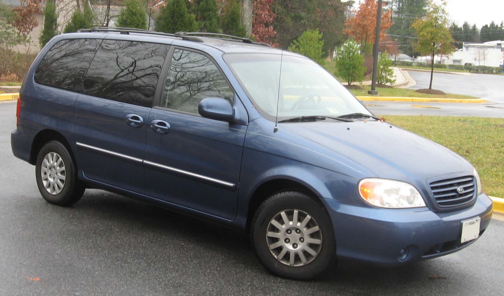 Side view of blue minivan with tinted windows