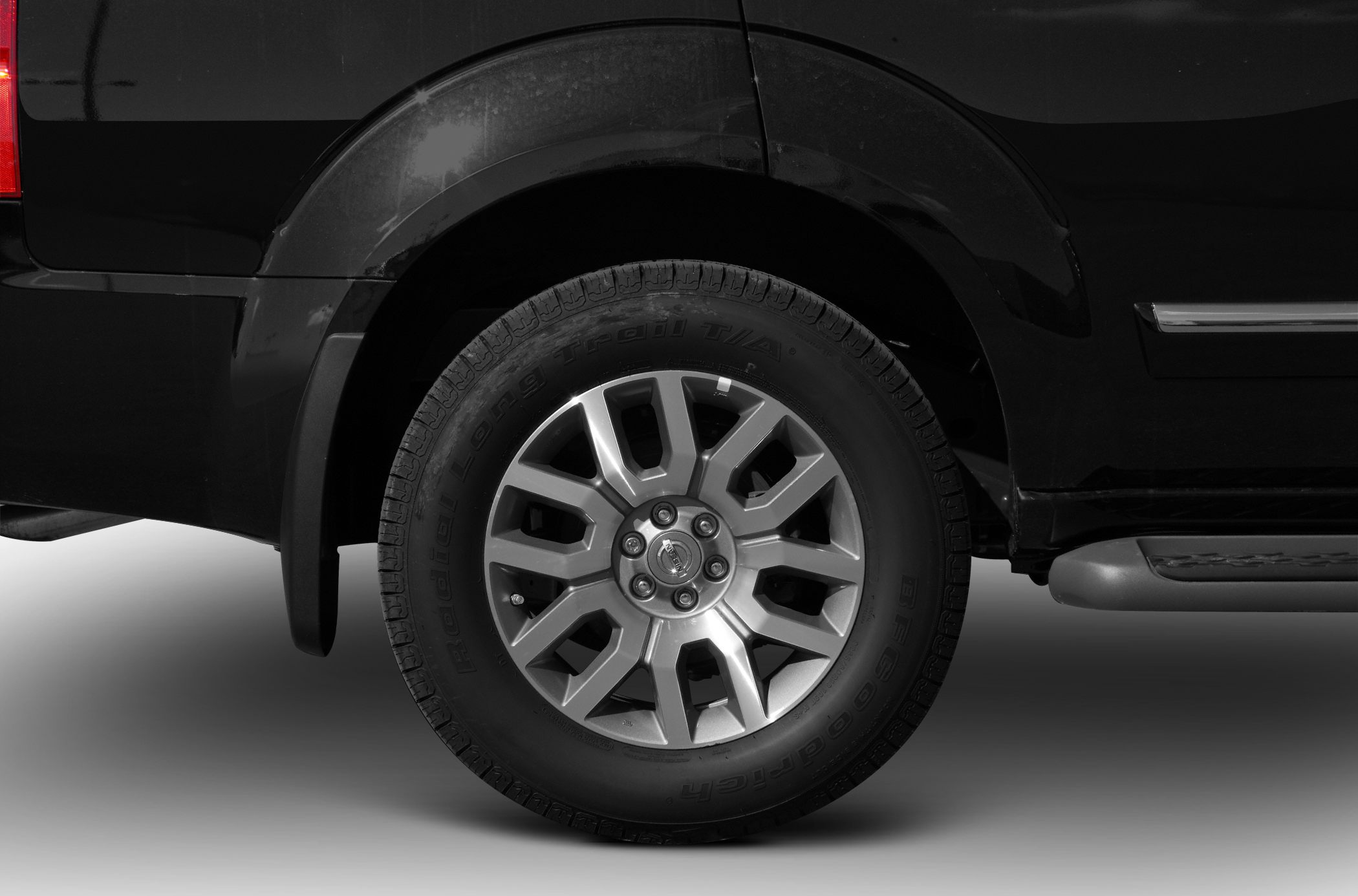 Alloy wheel and tire close-up with visible rim design and tire branding