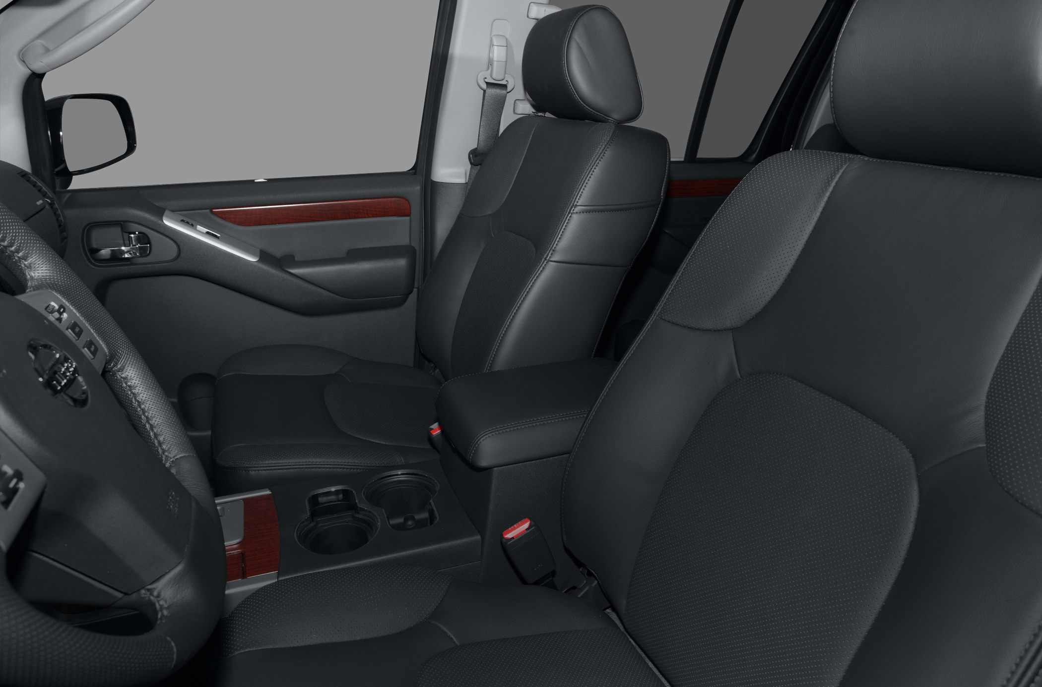 Front leather seats and door panel close-up with cup holders and armrest
