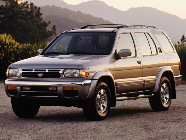 Front-side view of SUV with roof rack and running boards