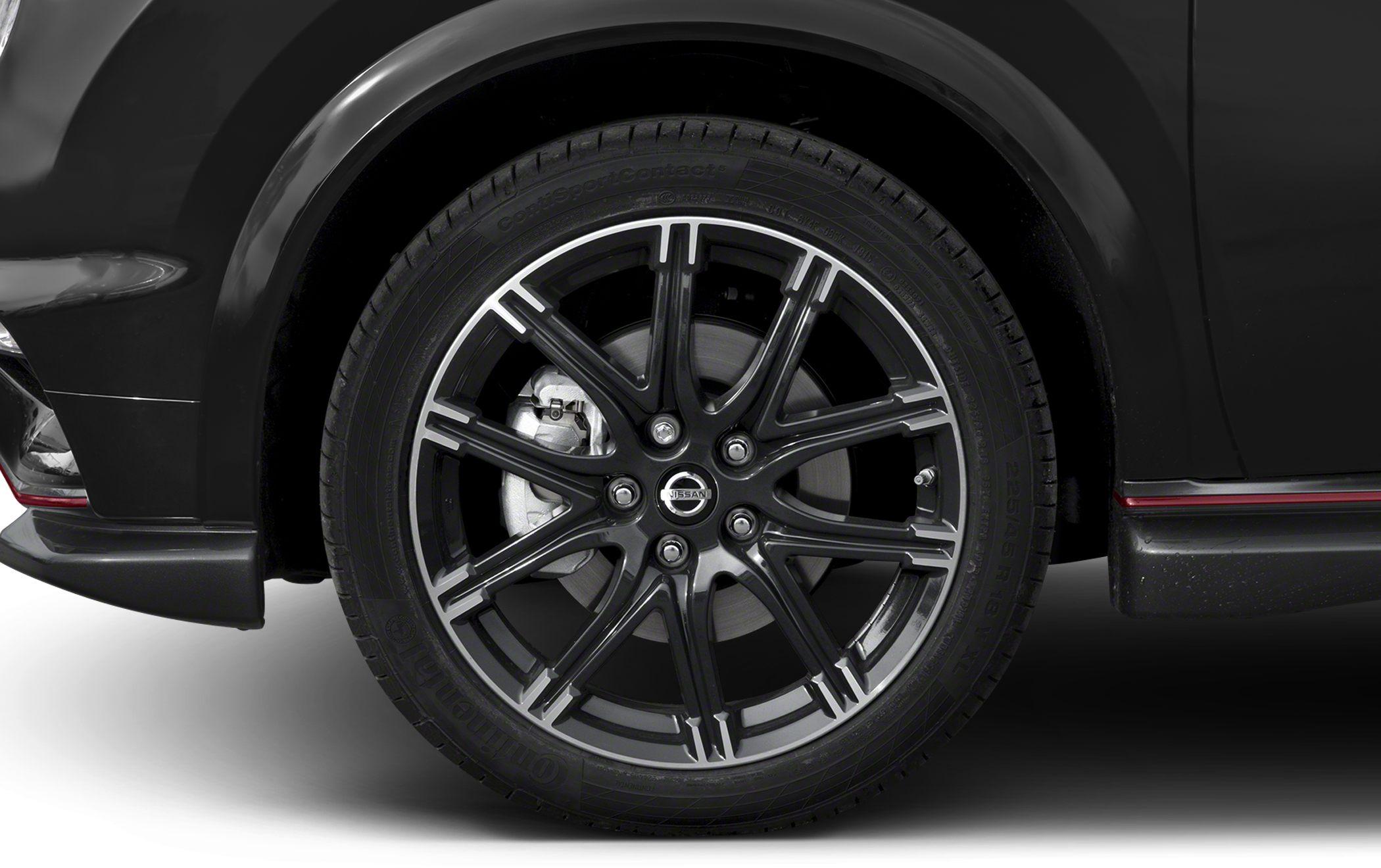 Alloy wheel and tire close-up with brake caliper, black glossy multi-spoke design.