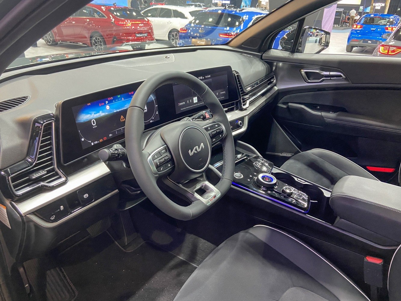Digital instrument cluster and dual infotainment screens on modern car dashboard