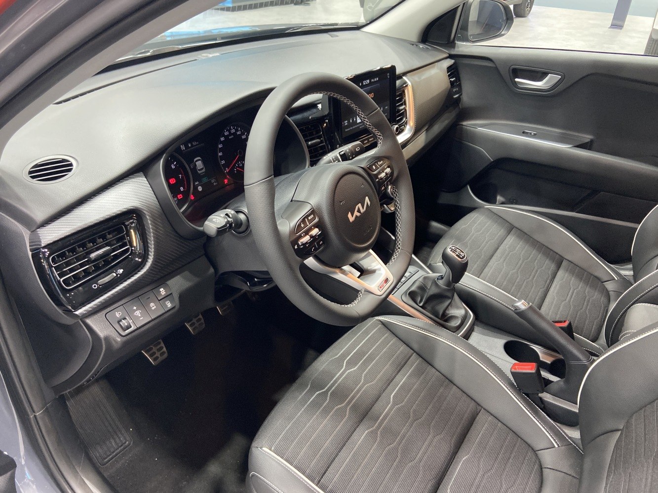 Modern dashboard with manual gearbox and leather steering wheel
