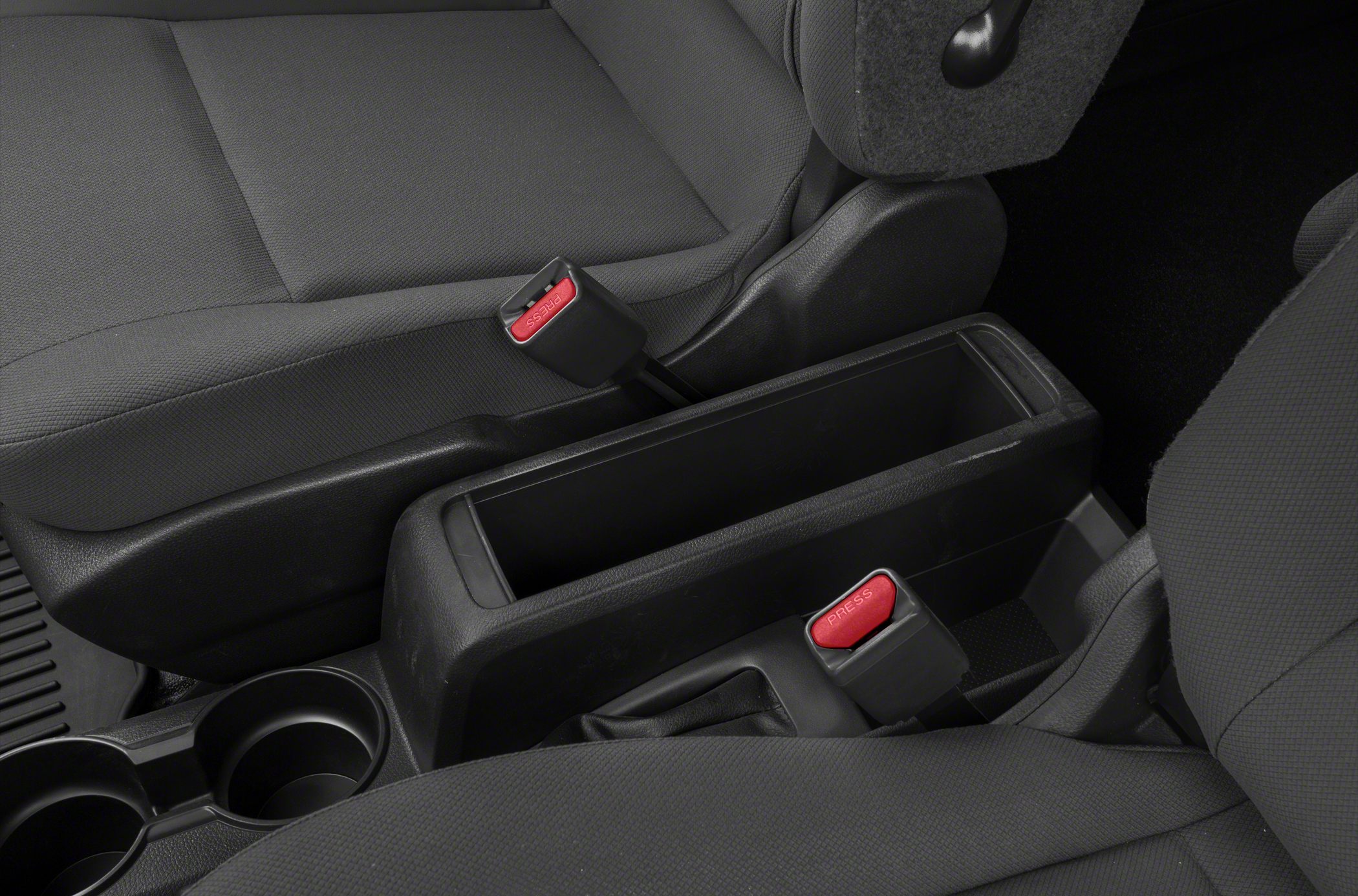 Center console storage with handbrake and seatbelt buckles