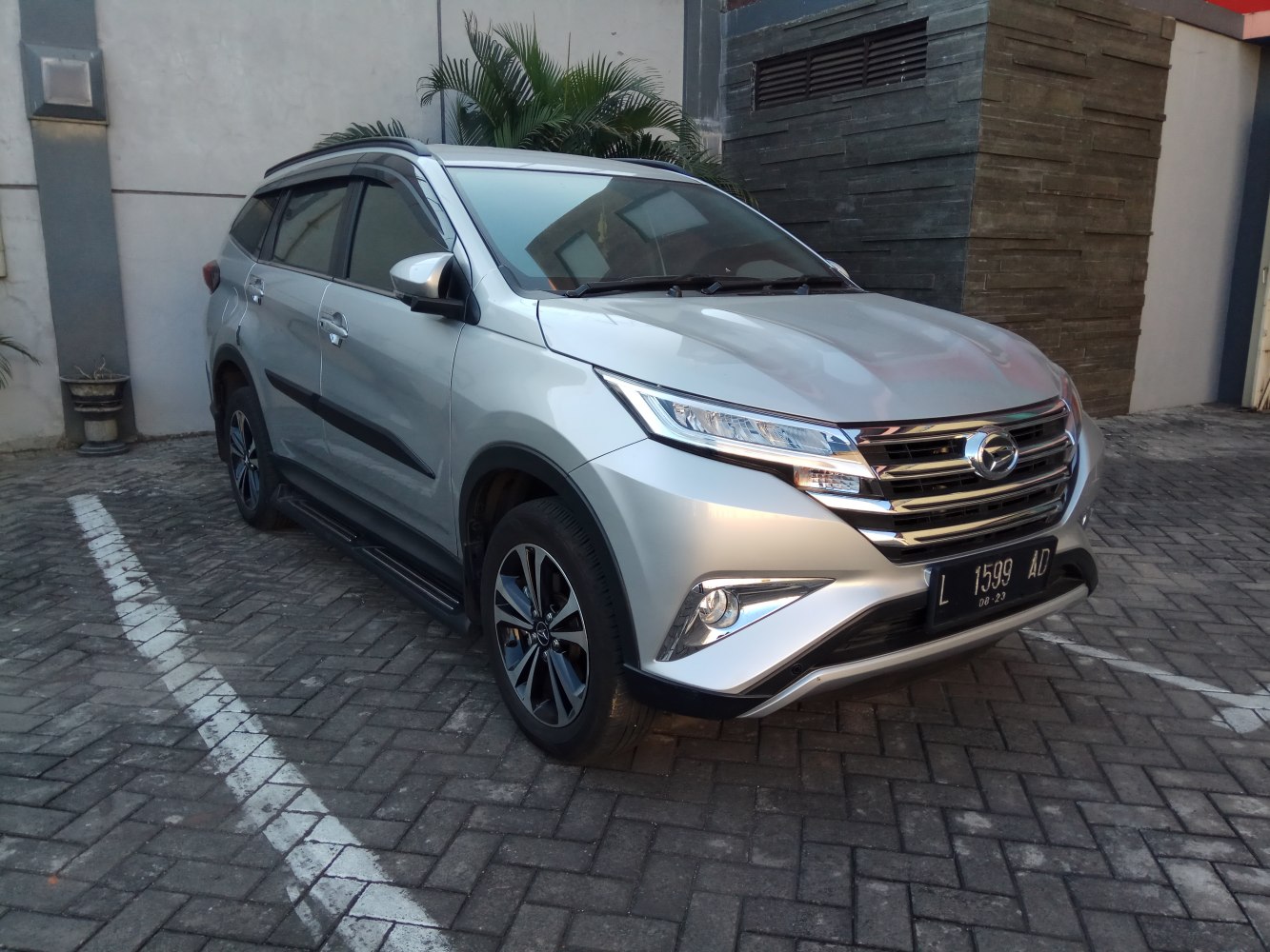 Silver SUV with LED headlights and alloy wheels parked.