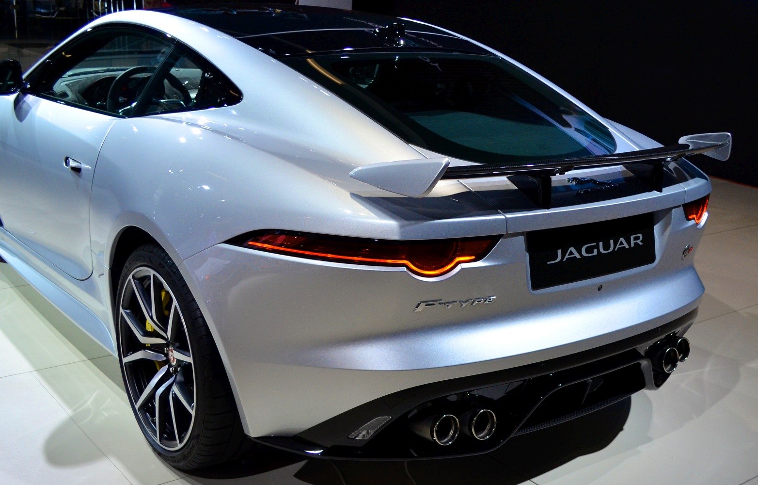 Rear design with spoiler, quad exhausts, and sharp taillights