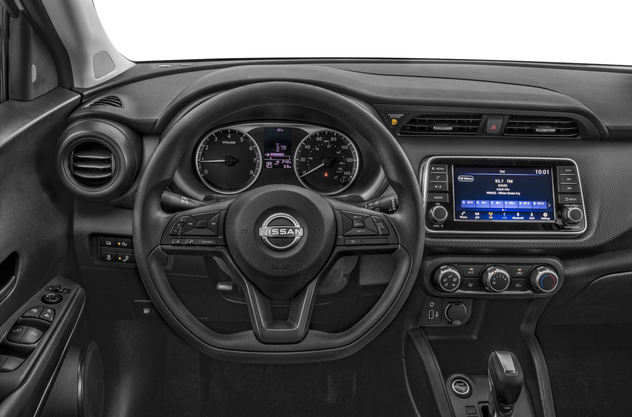 Steering wheel and dashboard with infotainment system, air conditioning, and gear selector.