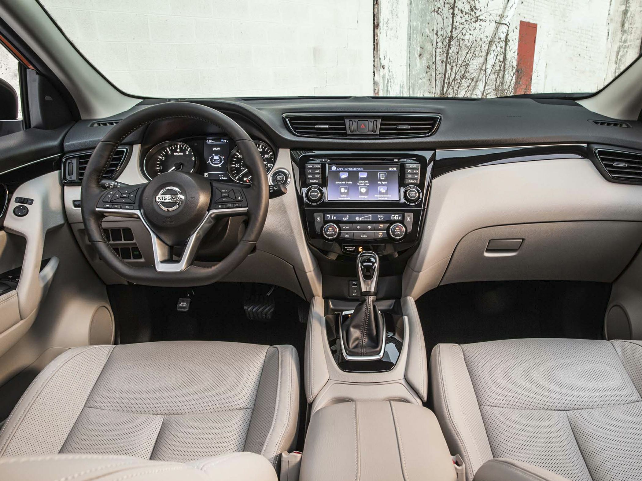 Dashboard with steering wheel, infotainment screen, and leather seats