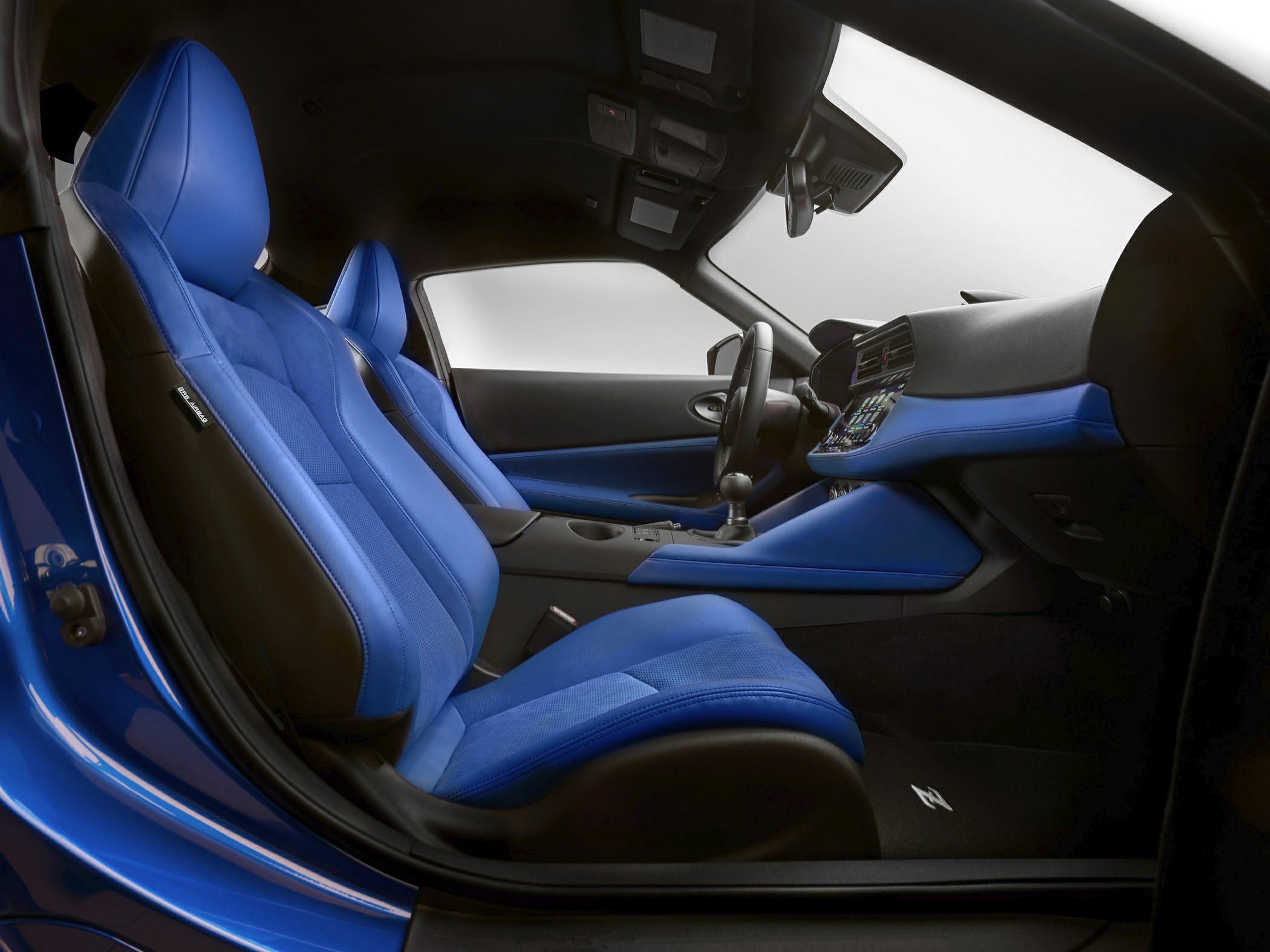 Blue sport seats and modern dashboard with manual transmission