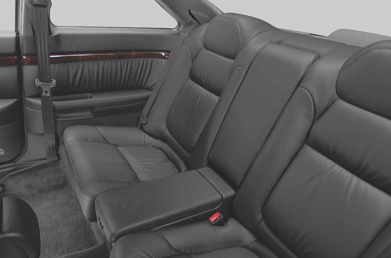 Black leather rear seats with center armrest and seat belts.