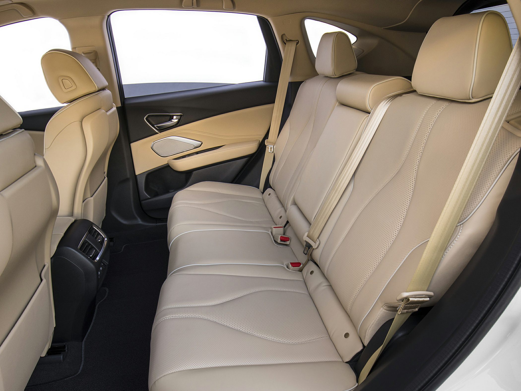 Beige perforated leather rear seats with seat belts and door panel