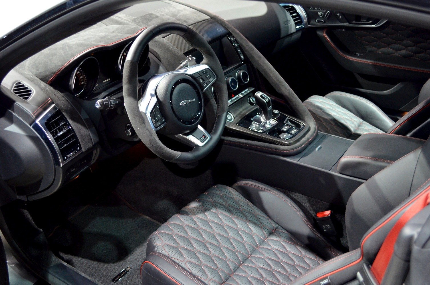 Luxury sports coupe interior with quilted seats and carbon fiber accents