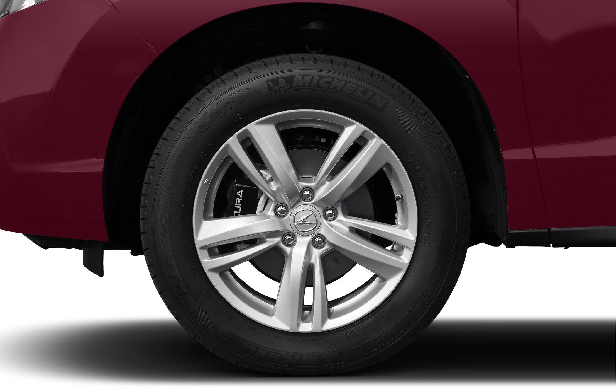 Close-up of alloy wheel with Michelin tire on red vehicle