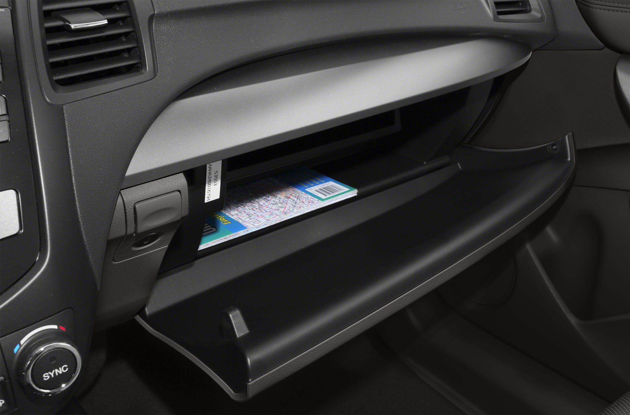 Open glove compartment with map and car interior details