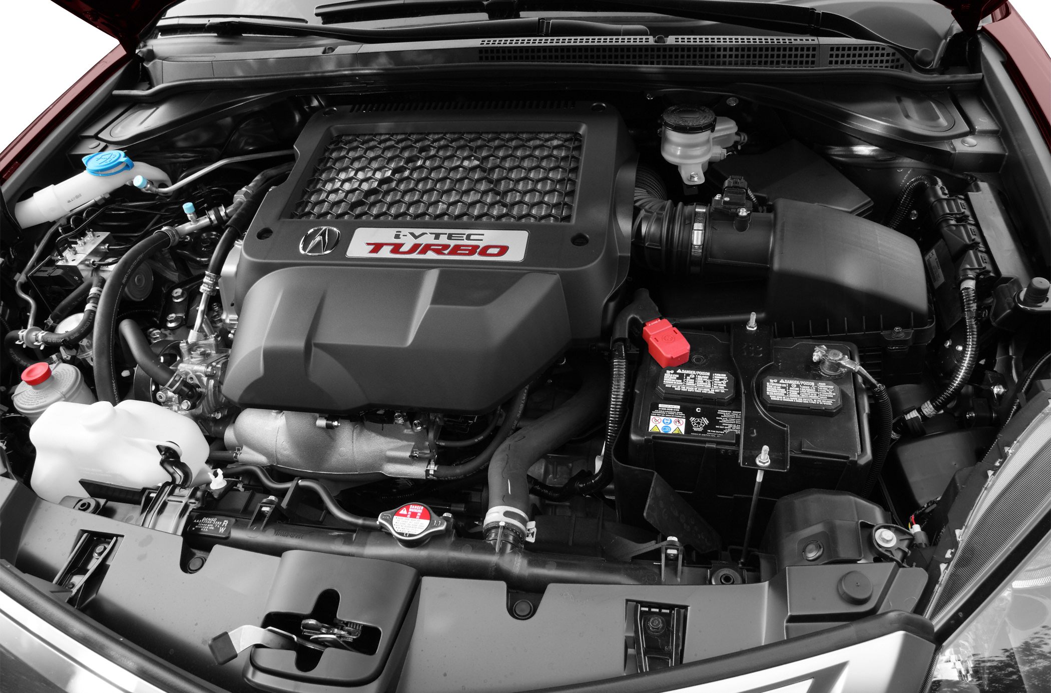 Turbocharged i-VTEC engine bay with components and battery.