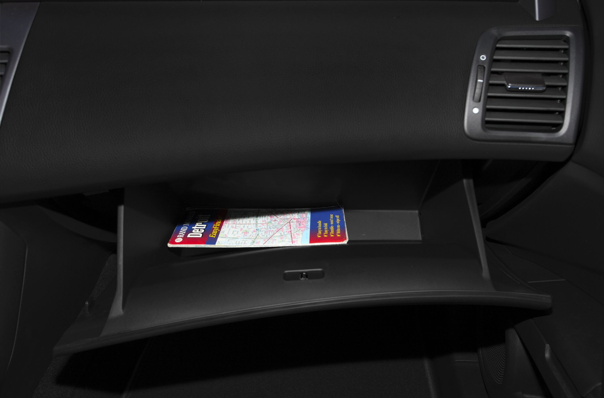 Open glove compartment with map inside