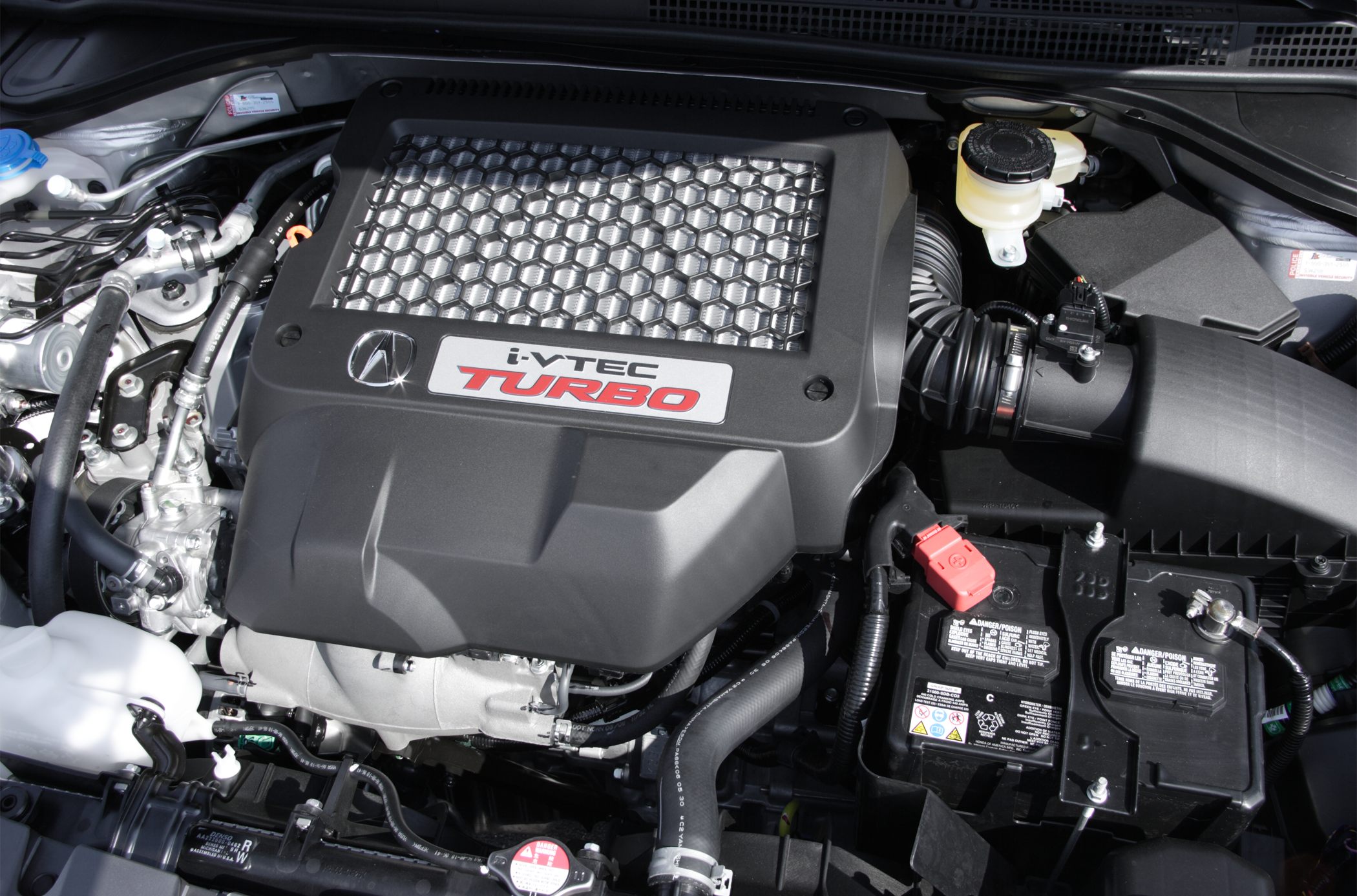Close-up of i-VTEC Turbo engine cover with engine components and battery.