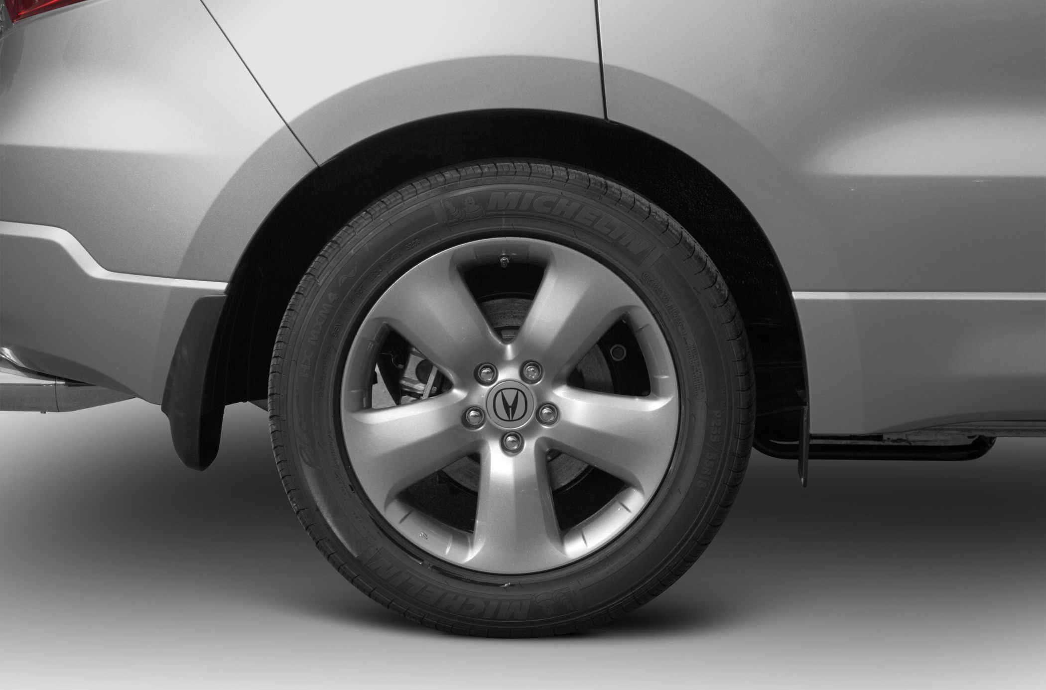 Close-up of alloy wheel with Michelin tire and mudguard.