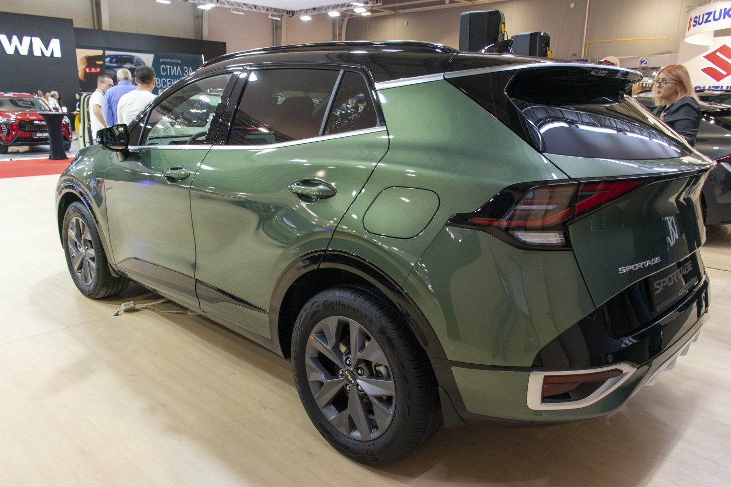 Green SUV rear side with sharp tail lights and alloy wheels