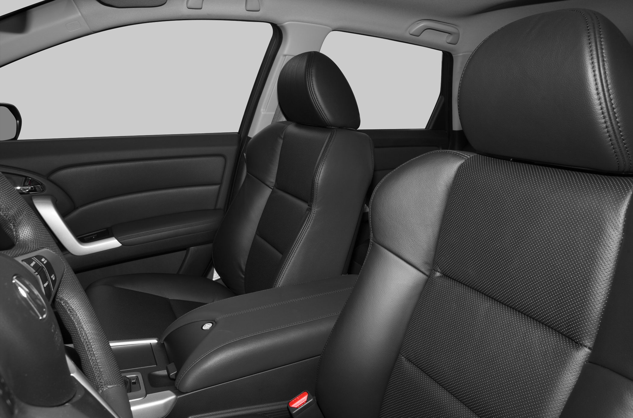 Close-up of black leather front seats with headrests and center armrest.
