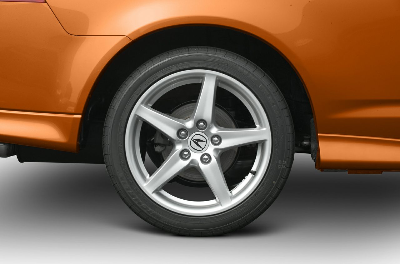 Five-spoke alloy wheel with brake rotor and orange rear quarter panel