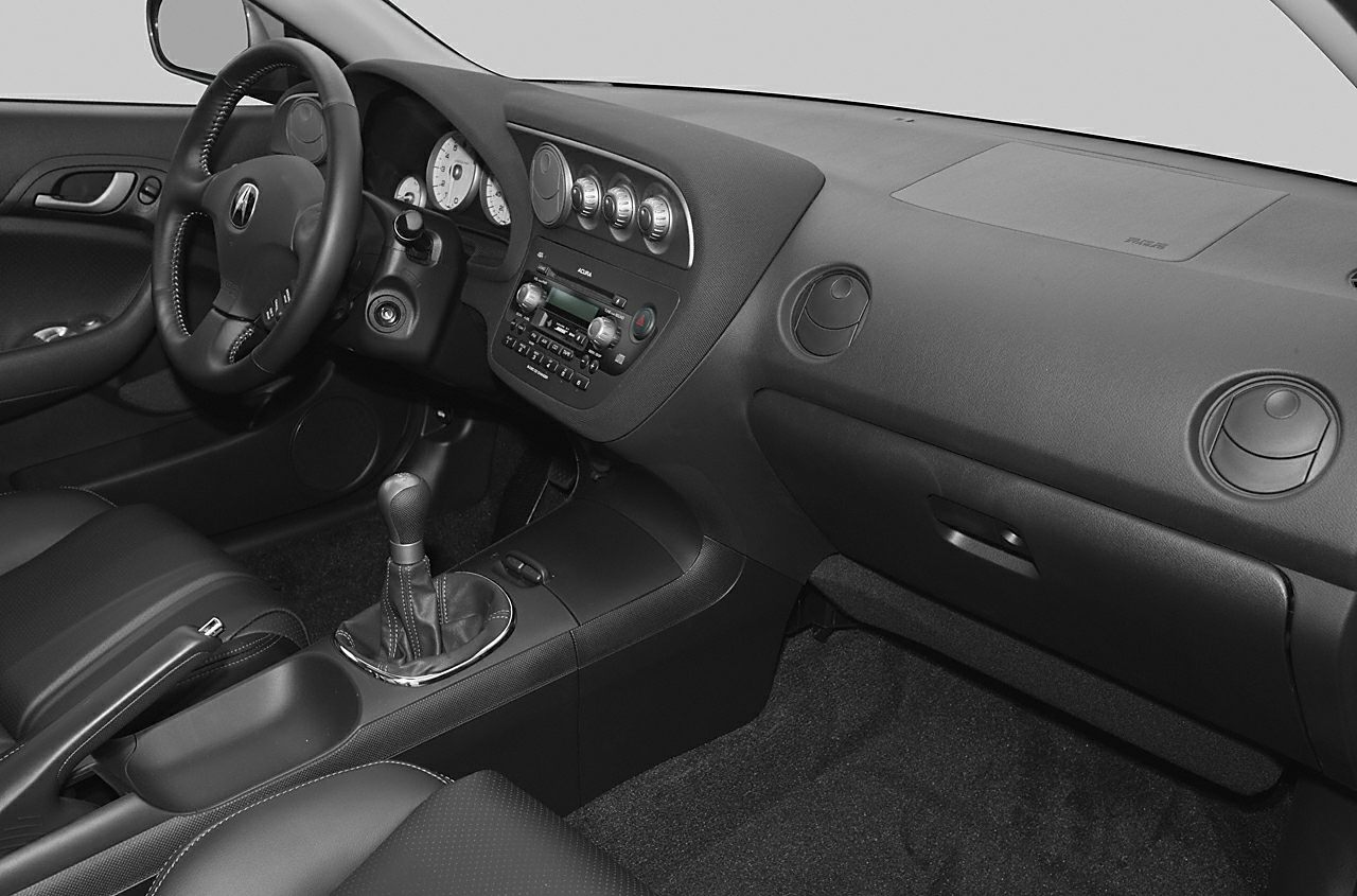 Dashboard, steering wheel, and manual gear shift in a car interior