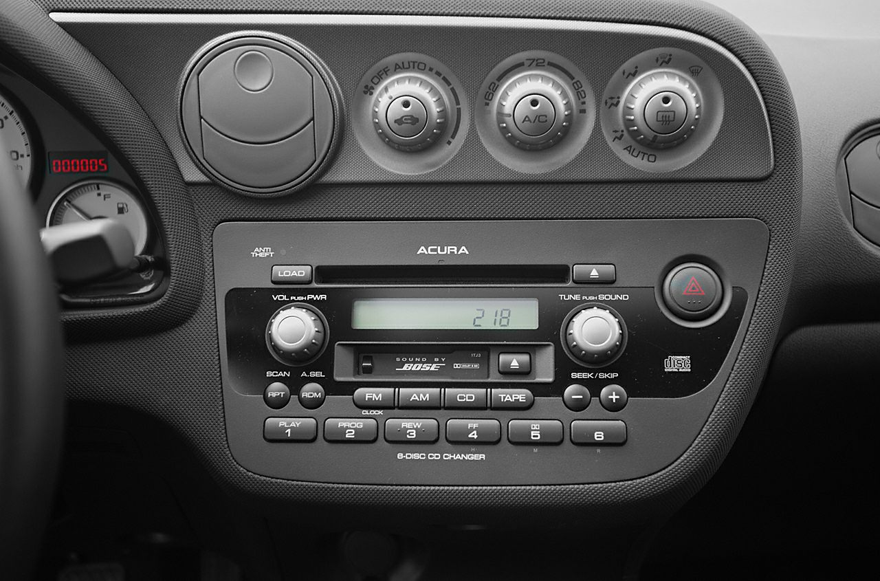 Vintage car audio system and climate control knobs on dashboard