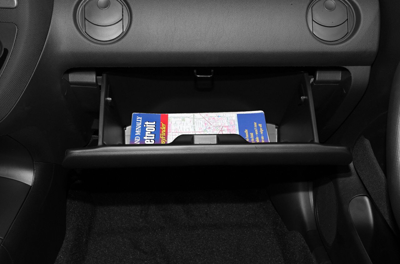 Open glove compartment with map storage inside car interior