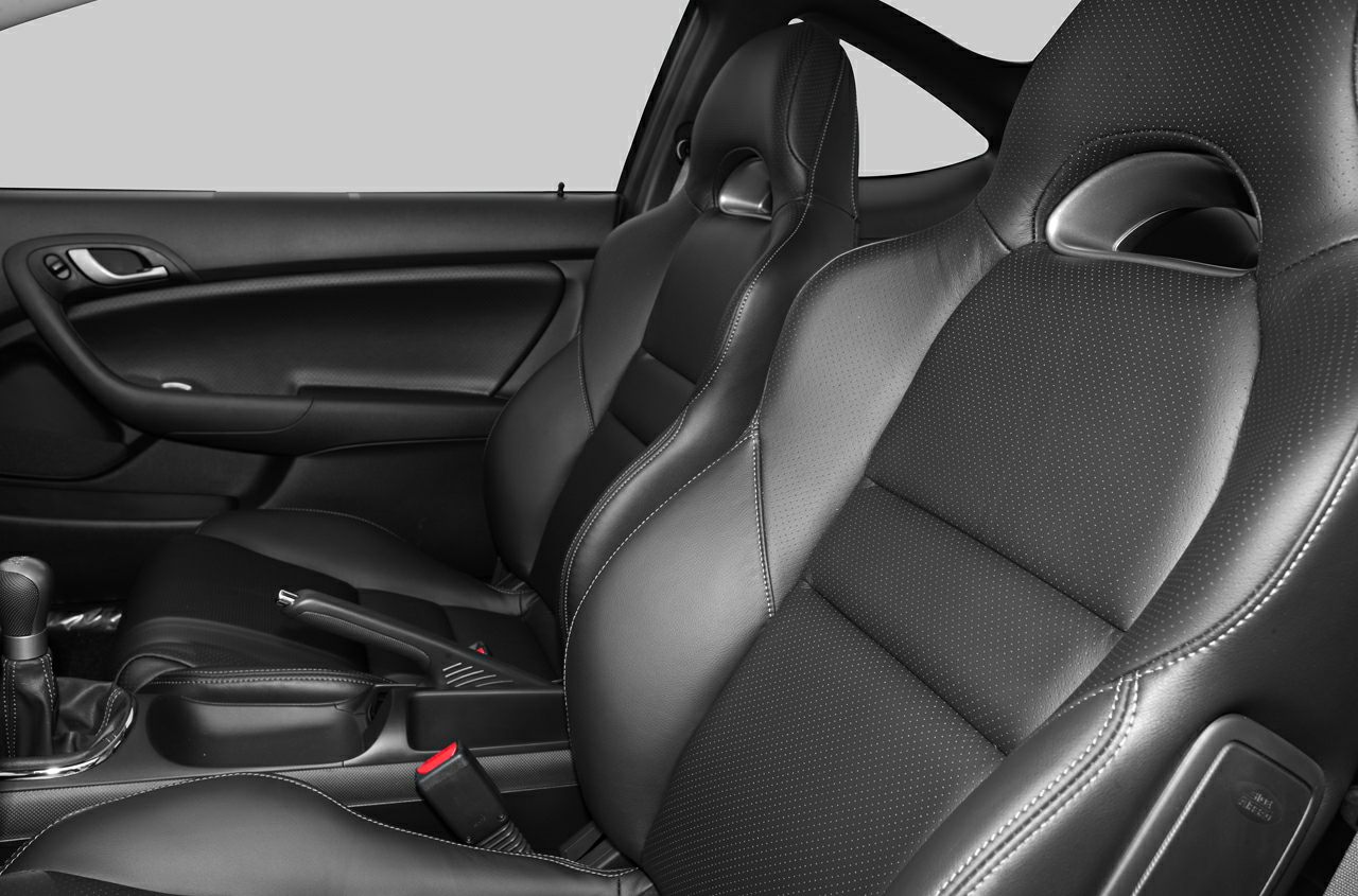 Sporty black leather perforated seats with detailed stitching and door panel