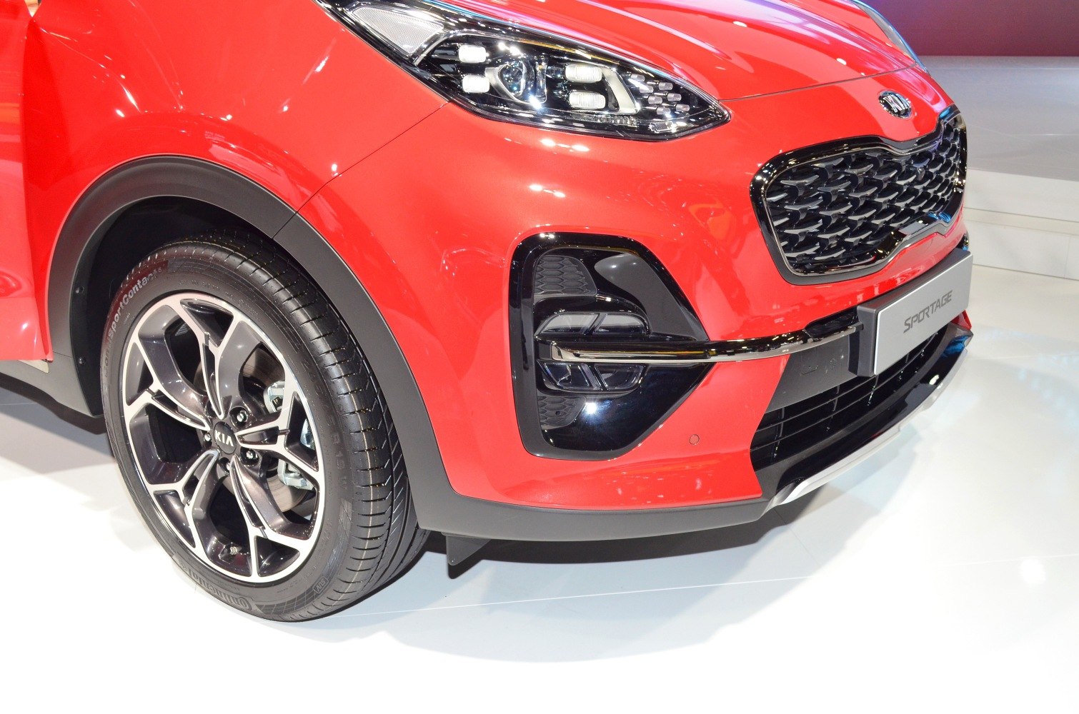 Front close-up with LED headlights and alloy wheel on red SUV