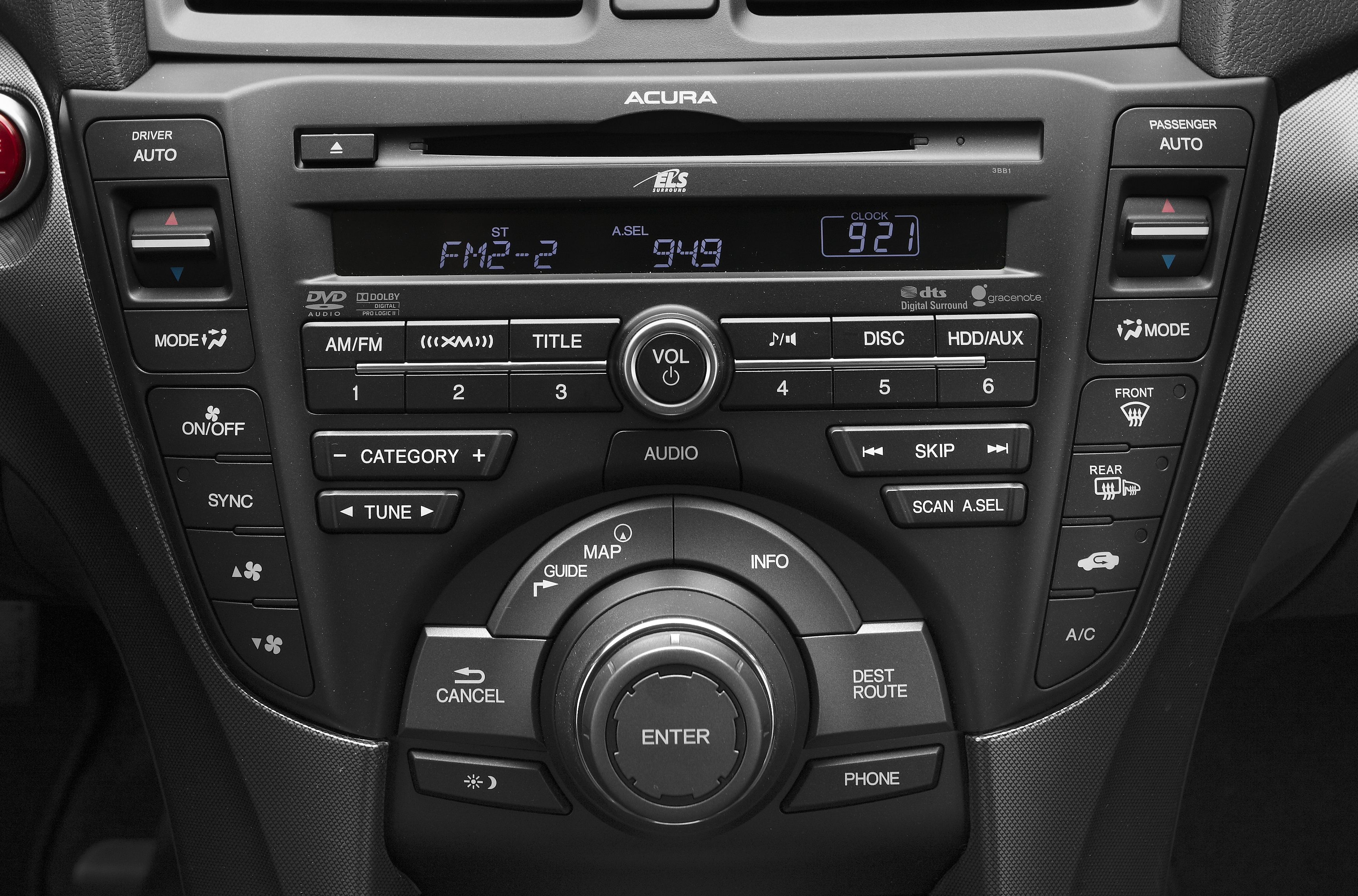 Car audio and navigation control panel with climate control buttons.
