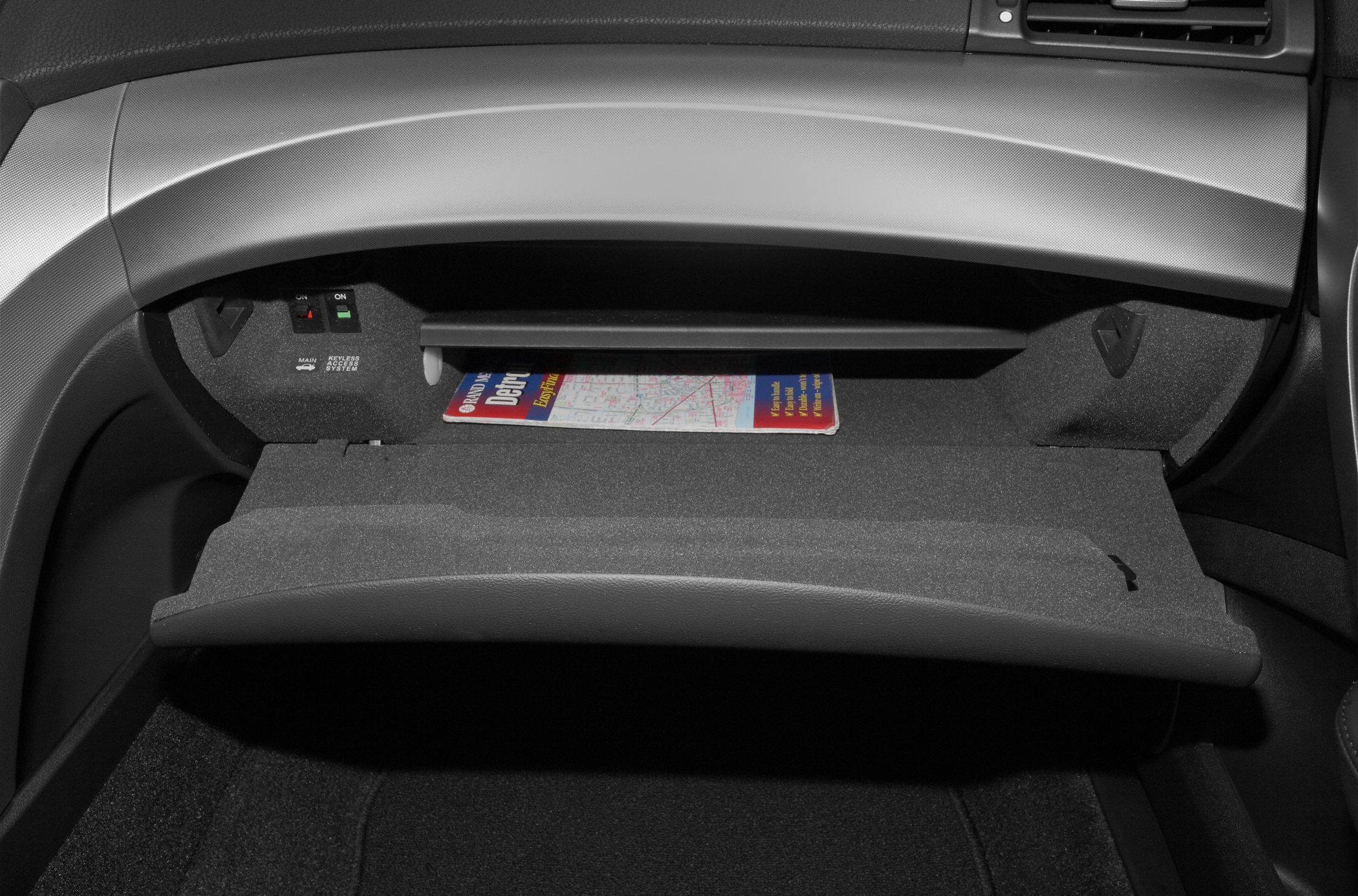 Open glove box with map and keyless access switches
