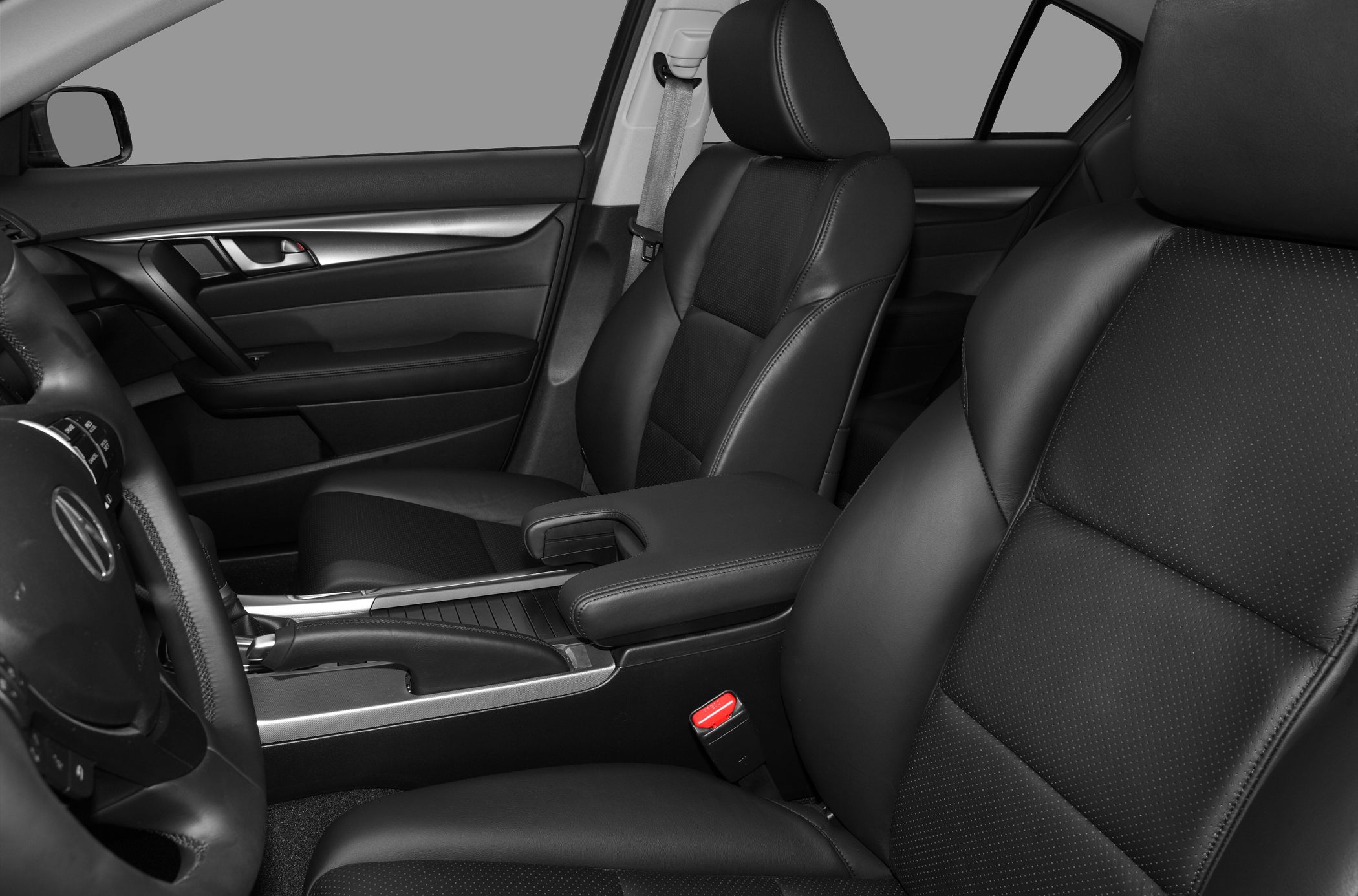Black leather front seats and interior armrest in close-up.